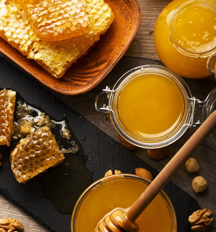 Honeycomb on slate tray with honey and nuts on kitchen table